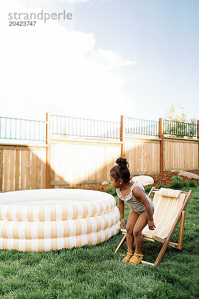 Toddler Girl Swimming in Inflatable Pool Backyard