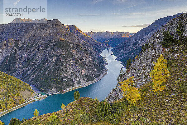 Lake of Livigno and larch tree woods in autumn  Valtellina  Italy