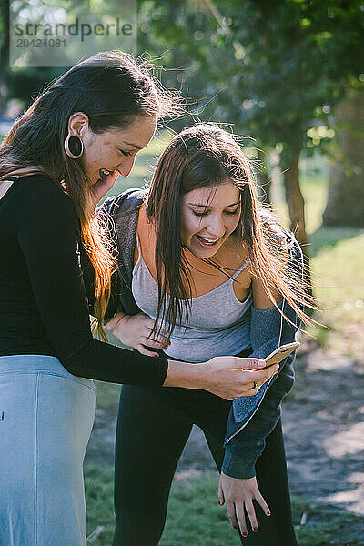 Couple Of Girl Friends Watching Their Phone.