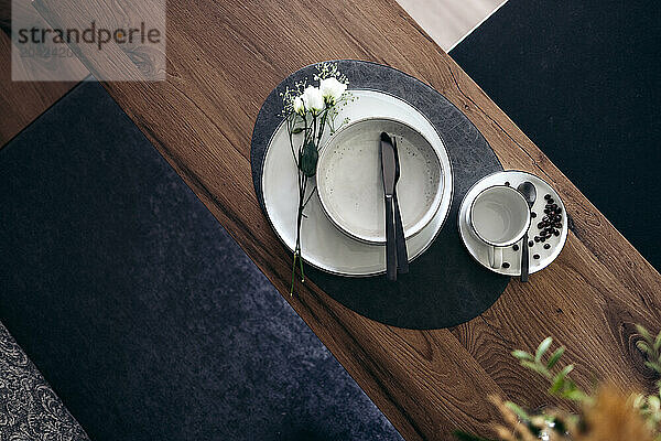 Elegant breakfast table with coffee  flowers  and utensils