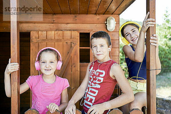 portrait of three boys in sportswear smiling looking at the camera