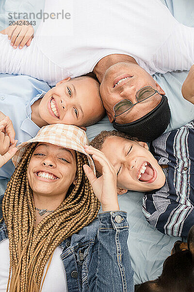 Family laying down laughing together