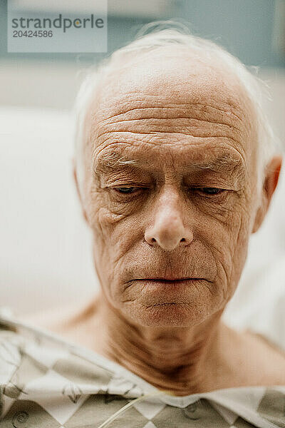 Portrait of elderly male cancer patient in oncology hospital