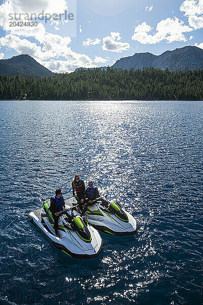 Three friends chat on their WaveRunners on Lake Tahoe  California.