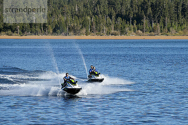 A man and a couple ride WaveRunners on Lake Tahoe  California.