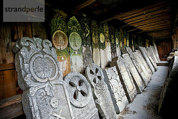 Headstone rest against a wall at a church in Vaga  Norway.