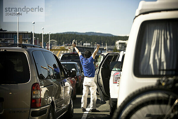 A man stretches waiting for the ferry boat during Summer.