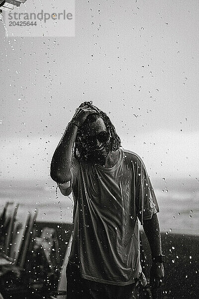 Young man walks in the rain.