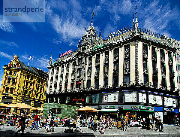 People walk through a shopping district in central Oslo  Norway.