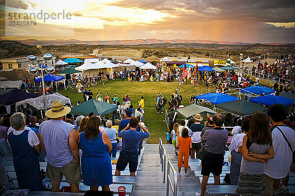 A crowd of people watch a dance at a powwow in Mesa Verde  Colorado.