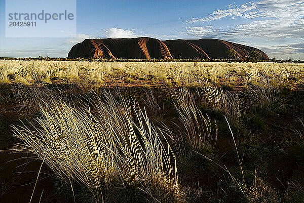 The sunrises over Uluru  Australia's sacred sandstone rock  more commonly known as Ayers Rock.