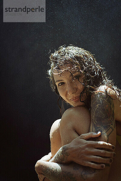 Woman traveler at the waterfall portrait close-up