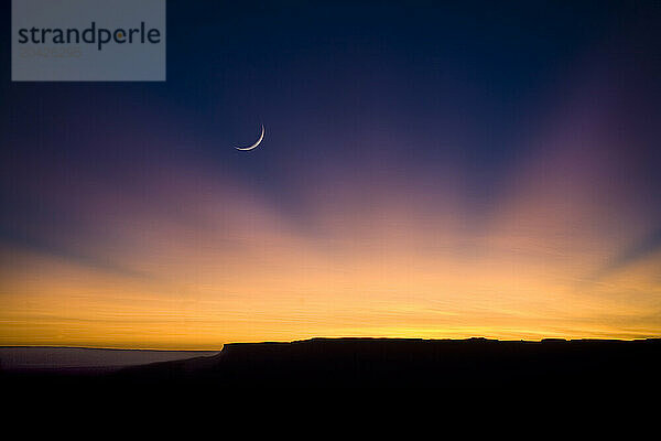 A new moon rises over Zion National Park in Utah.