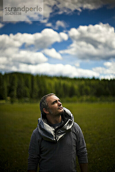 A man looks into the sky in a field near Leigh Lake in Montana.