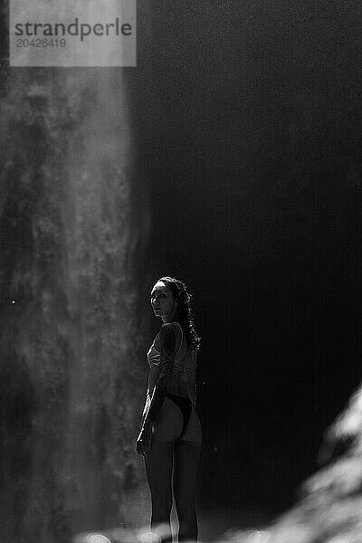 Tattooed woman traveler at the waterfall Nung Nung.