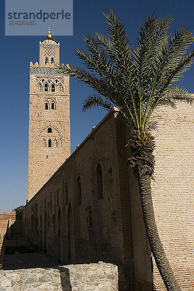 The minaret of Koutoubia Mosque stands against a clear blue sky in the center of Marrakech  Morocco  in North Africa.