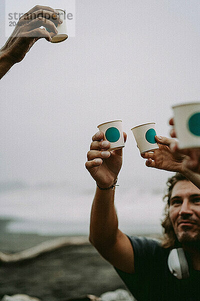 Friends having a picnic on the beach near the ocean.