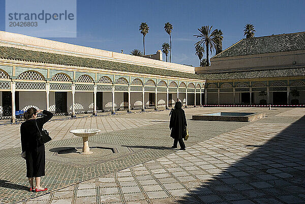 Tourists walk around the Bahia Palace in Marrakech  Morocco  in North Africa.