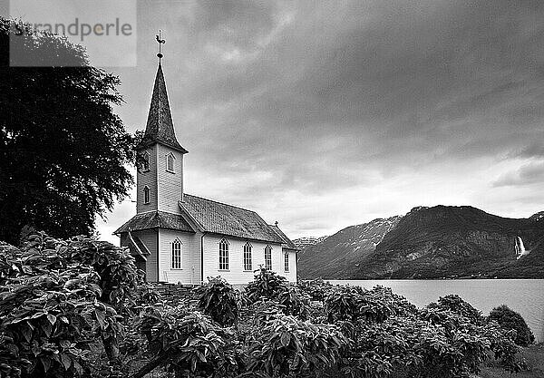 View of a church on the shore of a fjord in Norway.