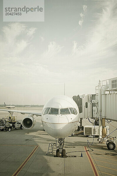 A small airplane sitting at the airport waiting to be boarded.