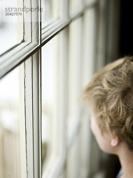 boy looks out the window