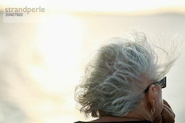 A tourist's hair blows in the wind