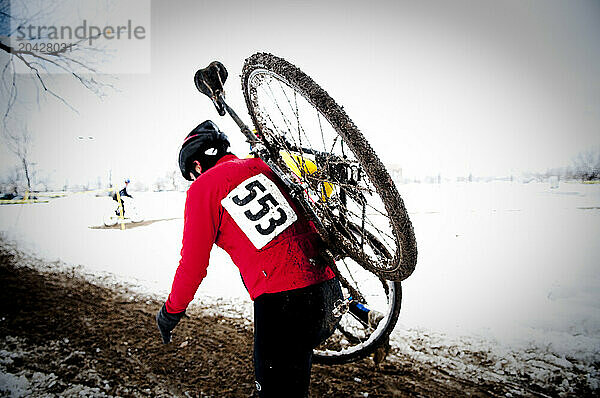 Cyclists race in the mud and snow at a Cyclocross race in Boulder  CO.