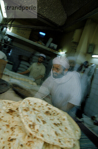 Bakers making hot bread  Dubai  United Arab Emirates.