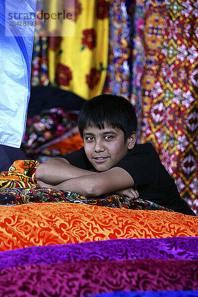 Selection of fabrics hanging from a market stall  Samarkand  Uzbekistan