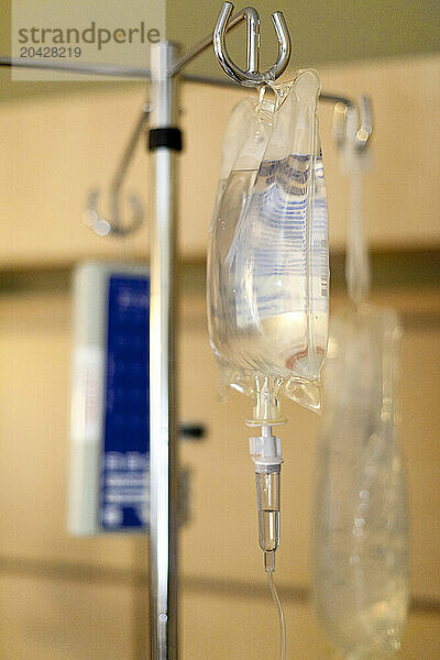 An IV drip bag hangs on a pole in the maternity ward of a hospital.