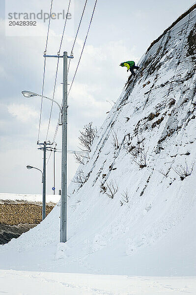 JP Tomich rides down a chainlink fence in Otaru  Tapan.