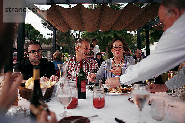 A group eating outdoors on a rural farm.