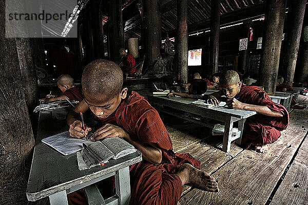 novice monks studying inside one of the temples of Ava. Mandalay. Myanmar