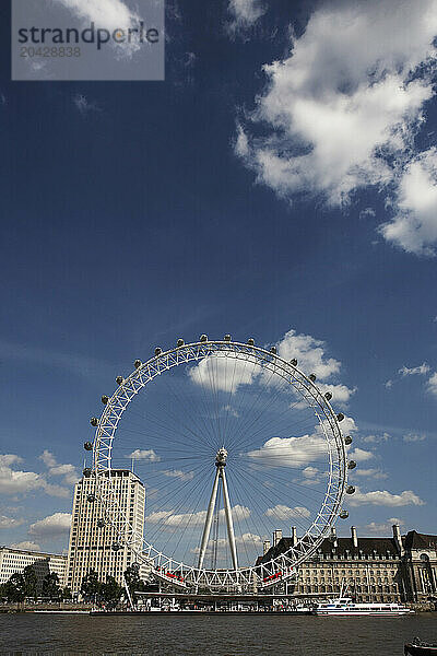 The London Eye  the big Ferris wheel that weighs 2 100 tonnes  is 135m in high  has a circumference of 424 meters and can carry 800 people at once  sit on the banks of the river Th