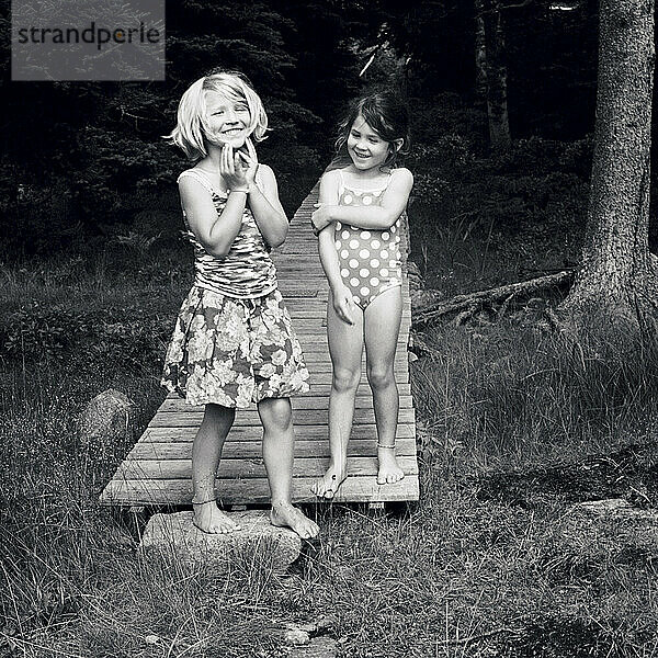 two young girls enjoy a laugh together