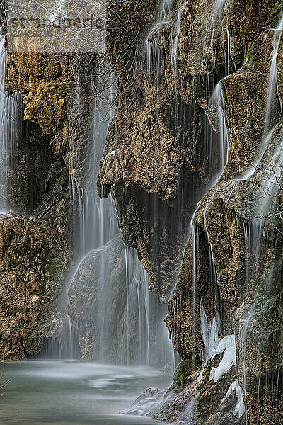 Waterfalls over jutting rocks at the source of the Cuervo river in Guadalajara  Spain.