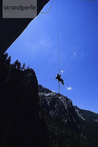 A climber ascends a rope in Yosemite national Park