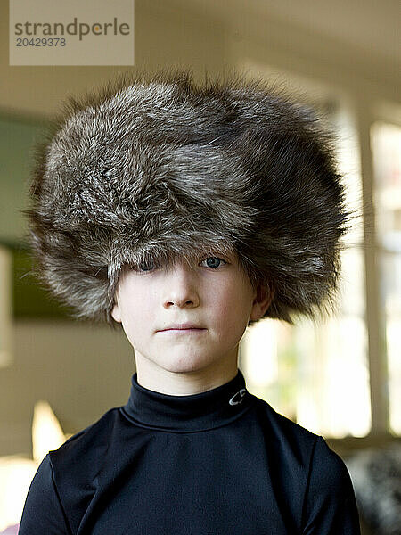 boy wears big fur hat