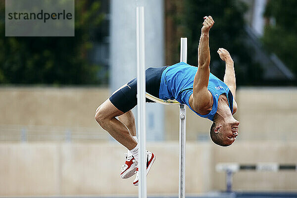 Athlete doing a high jump at Osterbro Stadium in Copenhagen.