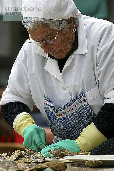 old woman preparing oysters in the market da pedra vigo pontevedra galicia spain