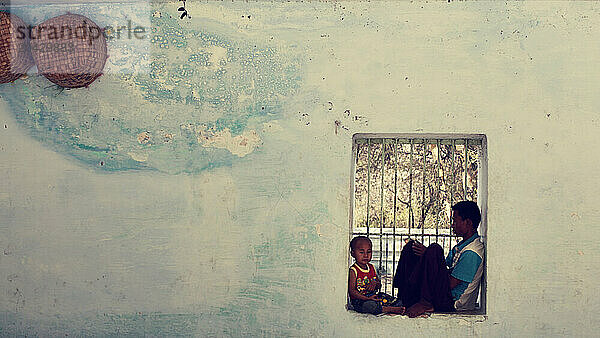 man and his son sitting in the window in the temple.