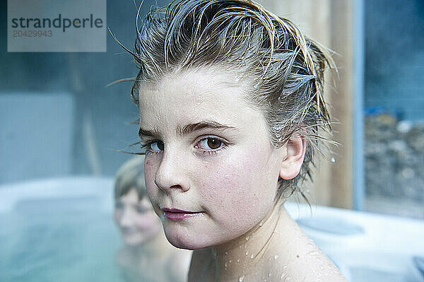 boy in hot tub with cool hair