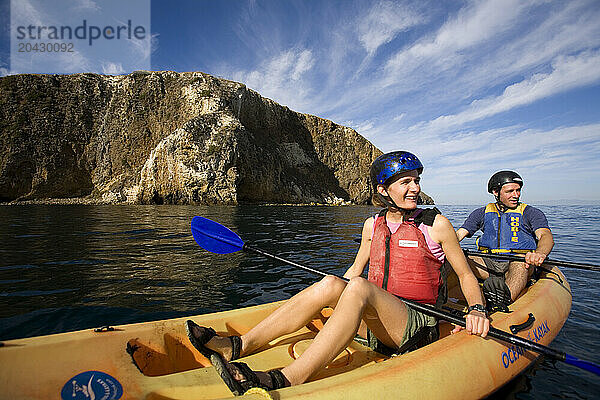 A couple sea kayaks along the shores of Santa Cruz Island  California.