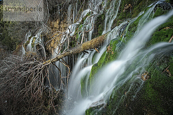 Waterfalls over jutting rocks at the source of the Cuervo river in Guadalajara  Spain.