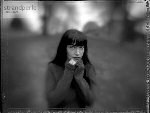 Black & White selective focus of a young woman in a field