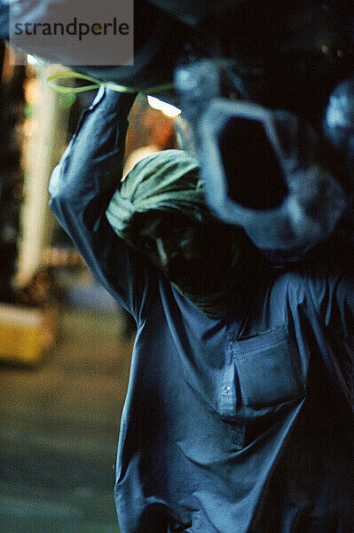 Man moving textiles in Dubai  United Arab Emirates.