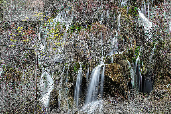 Waterfalls over jutting rocks at the source of the Cuervo river in Guadalajara  Spain.