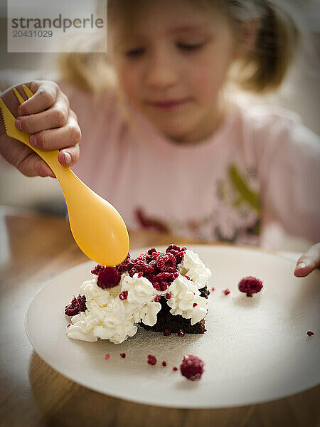 young girl makes dessert