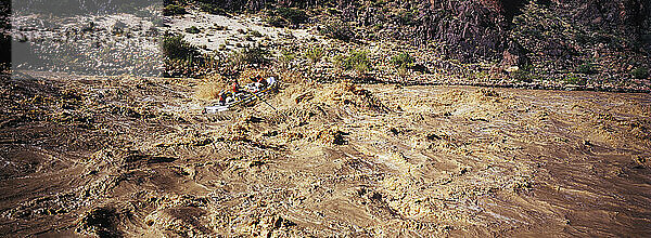 A rubber raft is tossed by a big wave in Hermit Rapid while whitewater rafting the Colorado River in Grand Canyon National Park