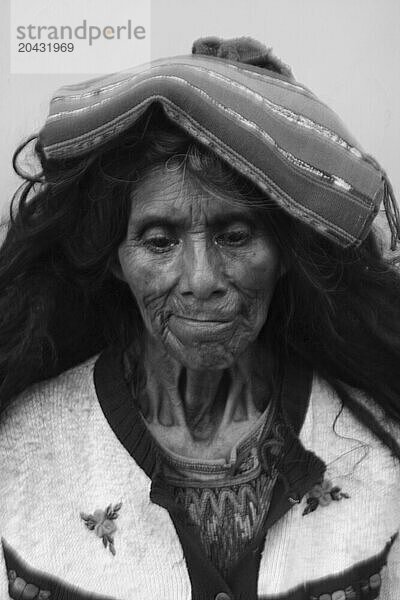 An old woman is lost in thought on the streets of Chichicastenango  Guatemala.